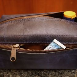 Real Leather Hoi An - Da Bao Real Leather: Blue colored buffalo leather toiletry bag, showing side pocket.