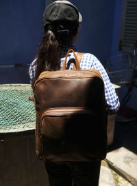Hoi An Real Leather - Da Bao Real Leather: Brown Vintage style laptop backpack with big front pocket. Big size Laptop backpack. Girl carrying it around town in Hoi An.